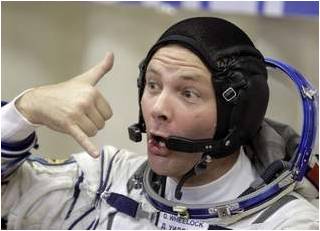 U.S. astronaut Doug Wheelock gestures Tuesday during the inspection of his space suit, prior to the launch of Soyuz-FG rocket booster with the Soyuz TMA-19 spacecraft carrying a new crew to the international space station (ISS) at the Russian leased-Baikonur cosmodrome, Kazakhstan.